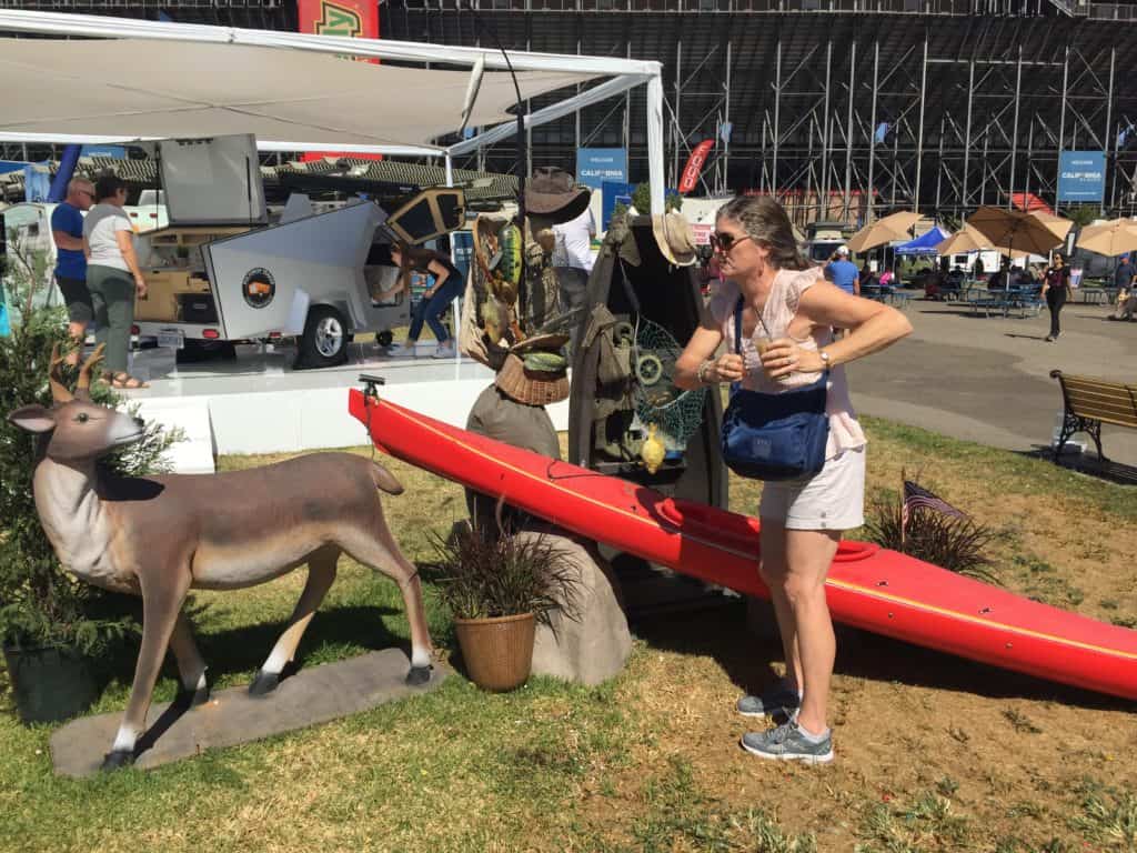 Julie, from The Places Where We Go podcast, having fun with the wild life/outdoor display at the California RV Show