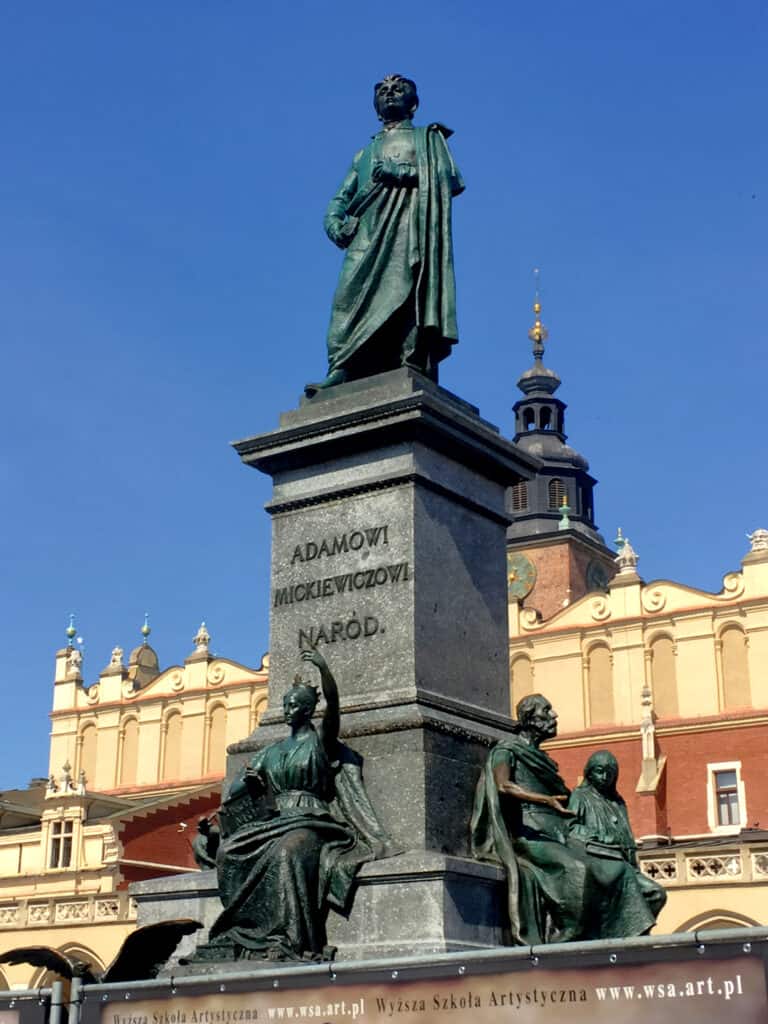 Adam Mickiewicz Statue in the great Market Square of Krakow Poland - photo by www.theplaceswherewego.com